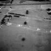 Oblique aerial view centred on the site of the Roman temporary camp with Broomlands House visible in the top left corner of the photograph.