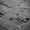 Oblique aerial view centred on the site of the Roman temporary camp with Broomlands House visible in the bottom right corner of the photograph.