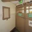 Interior. Ground floor, view of pay box for gallery seats and entrance door with stained glass