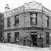 General view showing corner premises of Peter Lyon, Ironmongery Stores constructed in 1900.
