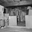 Interior view of the attic filled with boxes and chairs seen from the hatch.