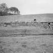 General view from W of threshing barn at NW side of steading, with horse-engine platform in foreground