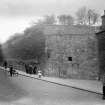 View of the Flodden Wall in Drummond Street seen from the Pleasance from the East. The South facade of No. 31a Pleasance can be seen along with children playing.