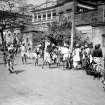 Street scene with possible game or betting with watching policeman, probably Kolkata.