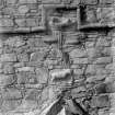 Detail of carved stonework incorporated into E side wall of tower.