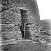 View of altered entrance, Mousa Broch with standing figure.