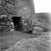 View of entrance to Mousa Broch, with standing figure.