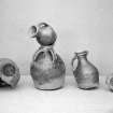 View of five pottery vessels.