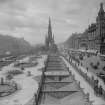 Historic view of Princes Street, Edinburgh showing Waverley Gardens and Scott Monument, trams, horse-drawn and motor traffic and pedestrians.