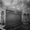 Interior.
View of auditorium and stage with curtain closed.