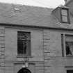 Scanned image of detail of first floor windows and dormer.