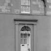 Scanned image of detail of front entrance, first floor niches and window.