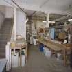 Interior. Lower ground floor. View of workshop from S