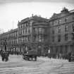 View of North Bridge at junction with Princes Street showing the Bridge Hotel on right, with horse and cart in centre of photograph. 
The buildings were demolished and this is now the site of the Balmoral Hotel.