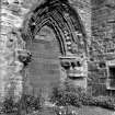Historic photographic detail of doorway in wall of S aisle.