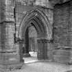 Historic photograph showing detail of doorway in NW corner of N aisle.