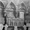 Historic photograph showing detail of tombstones and stone sculpture in sacristy.