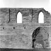 Historic photographic detail of doorway between cloister and S aisle.