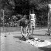 Seated ascetic or sadhu reciting from book, possible pilgrim, Kolkata.