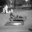 Amputee on trolley, Kolkata.  The High Court is visible in the background.