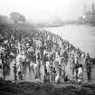 Crowded riverside with bathers, Chandpal Ghat, Kolkata.  Bathers reached the river through tunnels under the railway line.