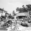 Waterside with group of washermen at a dhobi ghat.  Unknown location.