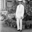 Unknown man standing outside house.
Unknown location.