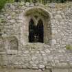 Interior. Traceried window and double stoup at E end of S wall, view from N