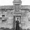 Historic photographic view of doorway in garden wall.