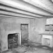 View of Scullery (?), wooden beamed ceiling and fireplace in South wing.