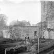 Remains of Chapter House and cloister garth looking north west