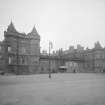 General view of main entrance front of Holyrood Palace showing James IV's Tower, part of Holyrood Abbey and Fountain in forecourt