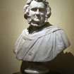 View of marble bust of Sir James Young Simpson, Bart, M. D. by William Brodie, 1871, at the top of the stairs, E side.