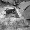 View of Kalemouth cairn during excavation showing cist and food-vessel urn.
