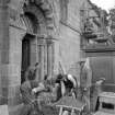 View of workers outside Dalmeny Parish Church.
