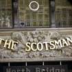 View of carved panel above entrance to The Scotsman Hotel, E side of building (North Bridge).