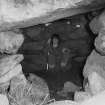 Gleann Mor, Structure F.
View of roofed cell with woman [Mary Harman?] within.