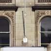 View of carved spandrels either side of arched windows on first floor of 104-106 Princes Street.