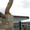 View of sculpture 'Leaning Figure', on top of wall beside steps outside Dance Base.