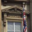 View of carved head and foliage, in pediment above first floor window, 38 St Andrew Square.