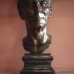View of bust of The Right Hon. Viscount Simon, K.C., on mantlepiece on E wall of entrance hall.