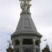 View of armillary sphere supported by children, on top of corner tower, 30 Princes Street.