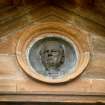 View of bronze portrait medallion of George Harrison, in the pediment of the Harrison Arch.