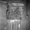 Interior-detail of capital on chimneypiece, depicting "family life"