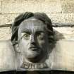 Detailed view of keystone head of Philippe Pinel, at top of arch in courtyard of former main entrance.