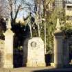 View of Robert Louis Stevenson Memorial, showing statues of David Balfour and Alan Breck Stewart, a portrait medallion of Robert Louis Stevenson inset into the pedestal, and railings.