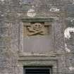 Detail of skull and crossbones in panel above entrance