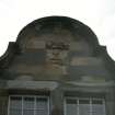 View of grotesque mask in gable.