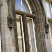 View of label-stop heads of Sir Walter Scott (left) and Robert Louis Stevenson (right), either side of ground floor window.