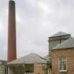 View from NE of boiler-house chimney, boiler house and former engine house, Victoria Works, Dunfermline.